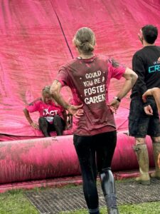 TACT foster carers and staff coming down the slide at Pretty Muddy Wakefield